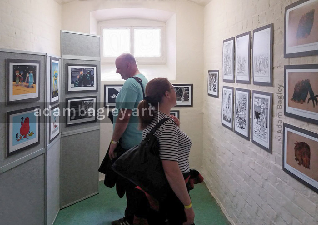 This image depicts the Adam Bagley Art exhibition set-up inside a prison cell at HMP Shrewsbury, as part of the international comic art festival Comics Salopia in 2019.